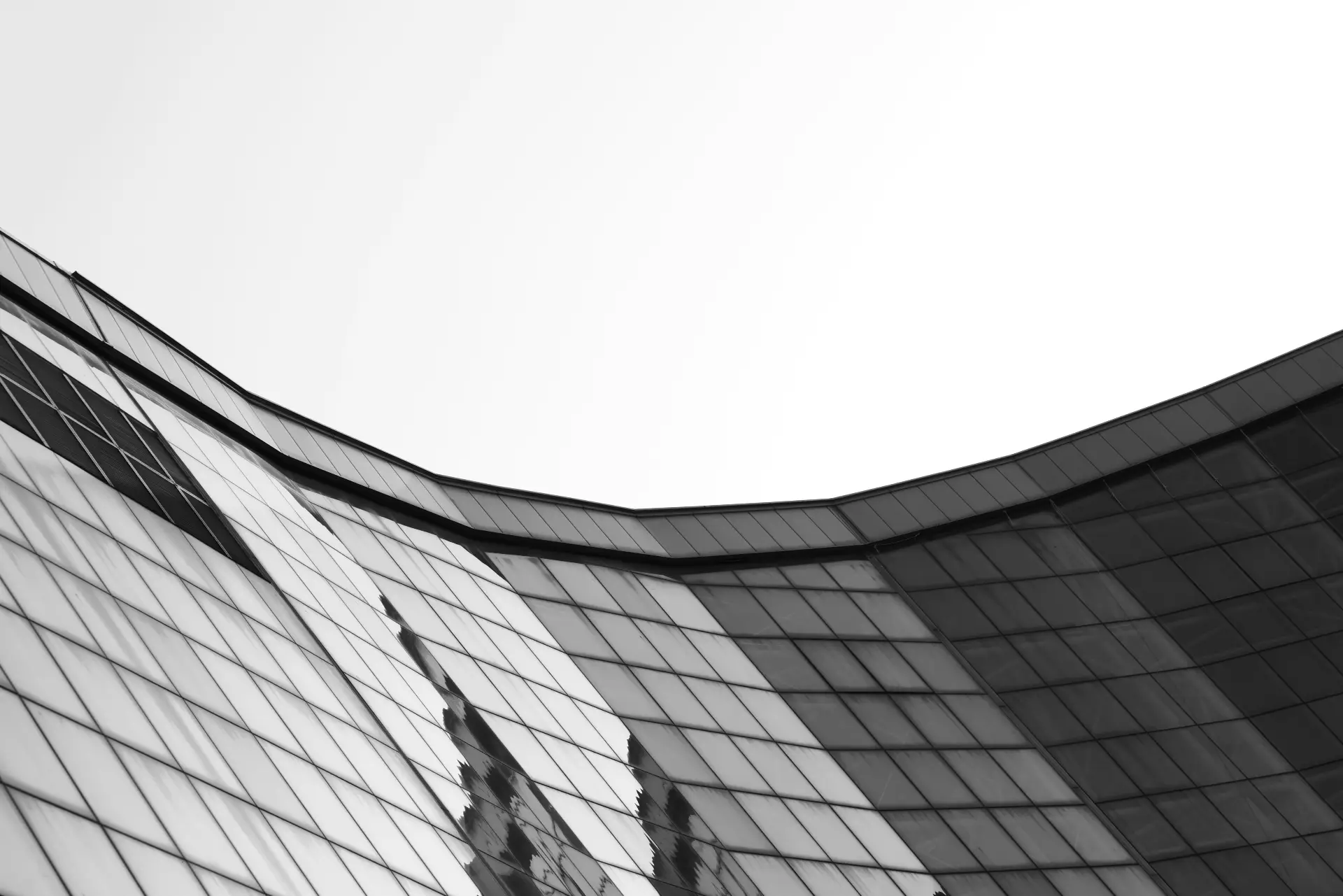 Sweeping curved architectural facade against sky