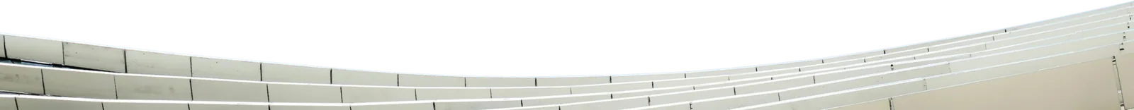 Curved architectural soffit of layered metal panels